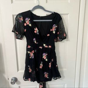 Black romper with embroidered flowers